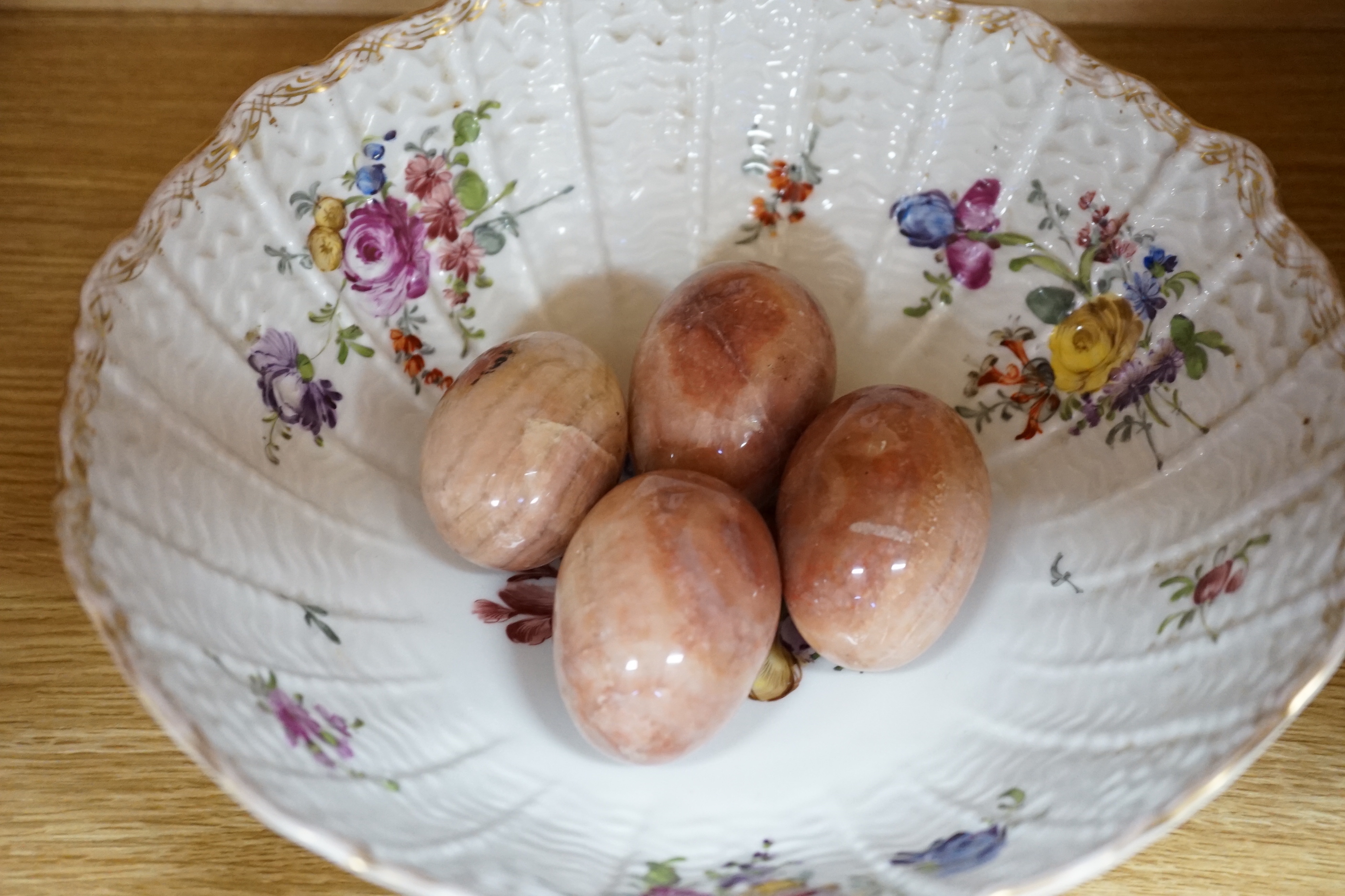 Ten sundry items including a small witch’s ball, three cherub figures with Meissen marks, a Continental bowl, four marble eggs, a Royal Navy ship in a bottle and another figure
